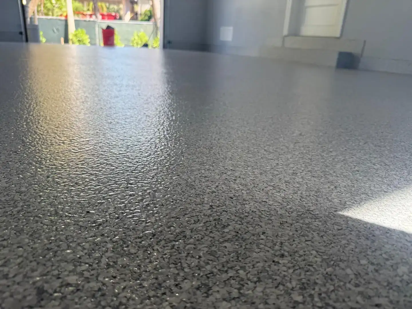 Garage with flake flooring lit by sunlight, Sunrise FL