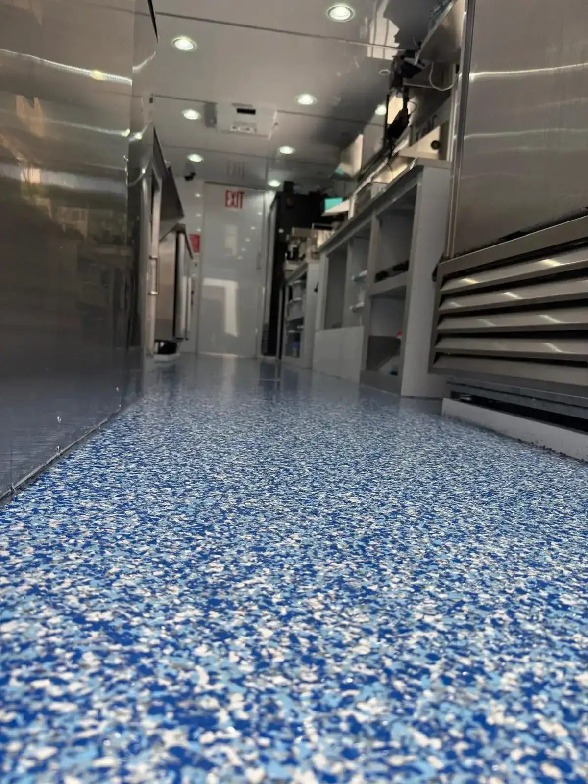 Trailer interior with blue slip-resistant flake flooring